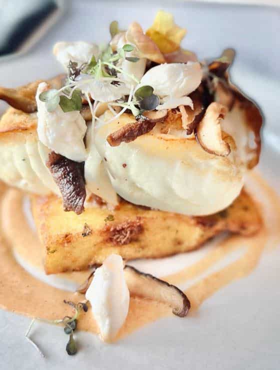 Close up view of a fish dish on white plate